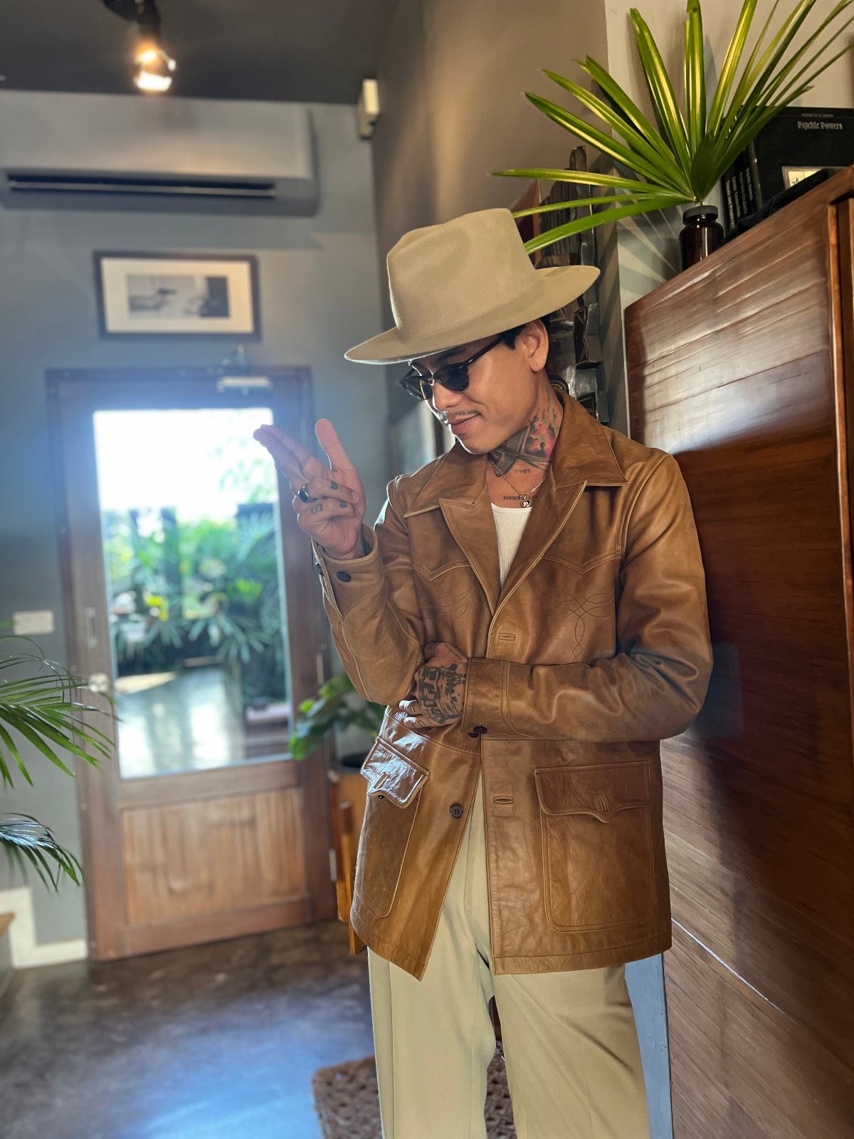 A man wearing a Suede tan jacket