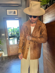 A man wearing a Suede tan jacket