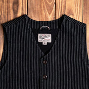 Pinstriped black vest with button-up front and two side pockets, styled against a wooden background, ideal for vintage or western-inspired outfits