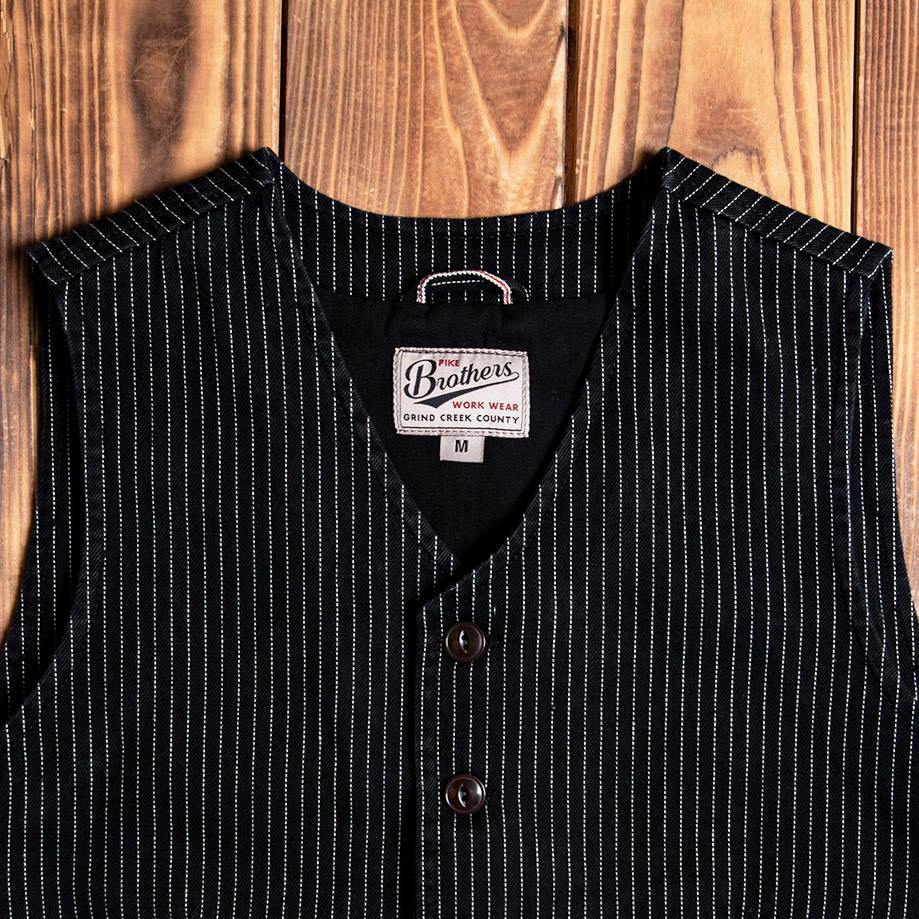 Pinstriped black vest with button-up front and two side pockets, styled against a wooden background, ideal for vintage or western-inspired outfits