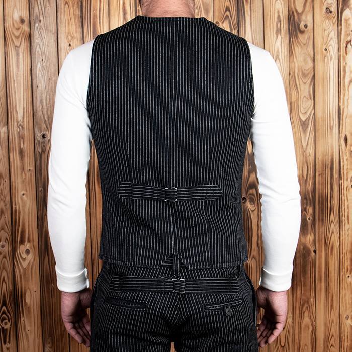Pinstriped black vest with button-up front and two side pockets, styled against a wooden background, ideal for vintage or western-inspired outfits